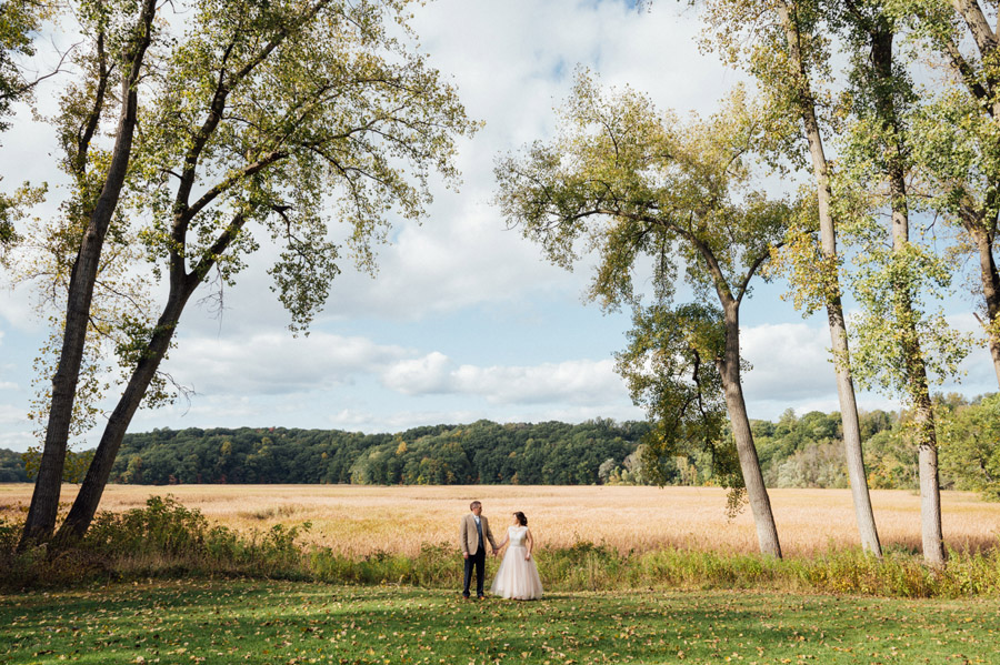 Rochester wedding at Glendoveers.  Bride and groom holding hands in front of scenic view.