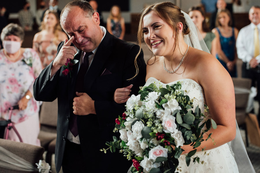 Best Rochester wedding photographer - Bride and Dad walking down the aisle crying