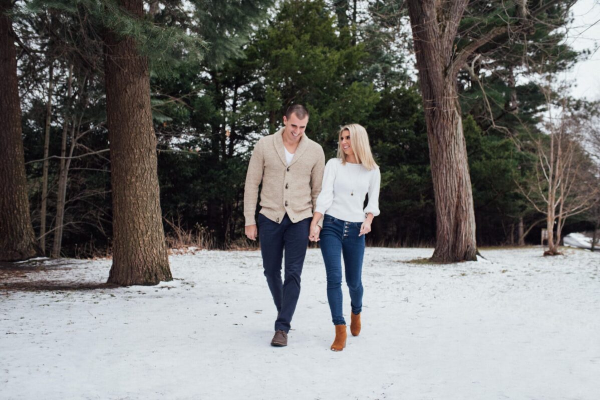 Rochester Photographer - couple walking in snow - Engagement session - Durand Eastman Park